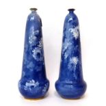 * A pair of Doulton Burslem bottle vases decorated in blue with chrysanthemums, 39cm high