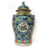 * A Chinese porcelain jar and cover painted in famille rose enamels with birds in branches on a