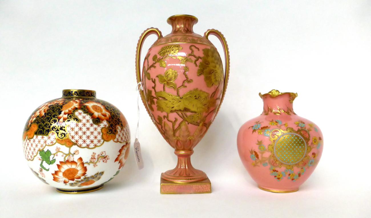 * A Royal Crown Derby pink ground urn shaped vase with gilt decoration, 24cm high; a similar smaller