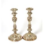 A pair of Old Sheffield Plate candlesticks, chased with rococo style scrolls and shells