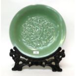 * A Chinese celadon glazed charger and stand, 40cm diameter