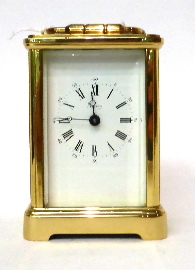 * A brass carriage timepiece, retailed by Asprey, 20th century, carrying handle, white dial with