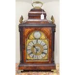A mahogany striking table clock, inverted bell top with a carrying handle and pineapple finials,