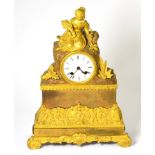 A gilt metal striking mantel clock, circa 1840, surmounted by a harvest lady, enamel dial with Roman