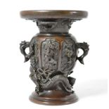 # A Meiji period Japanese bronze vase, with twin-handles the body cast with phoenix, dragon and