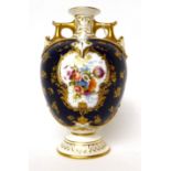 * A Royal Worcester porcelain blue ground twin-handled vase, painted by E Phillips with a flower
