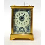* A brass carriage timepiece, circa 1900, carrying handle, enamel dial with Arabic numerals and