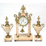 A marble and gilt metal striking mantel clock garniture, early 20th century, four columns raised