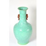 A Chinese green glazed baluster vase with red mythical beast handles and foliate decoration, 32cm