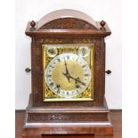 A quarter striking table clock, circa 1890, arched case, side sound fret doors, brass dial with a