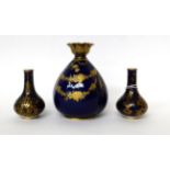 * A pair of early 19th century Derby porcelain blue ground bottle vases with gilt decoration, 9cm