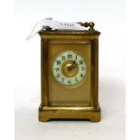 * A small brass carriage timepiece, circa 1900, carrying handle, enamel Arabic chapter ring,