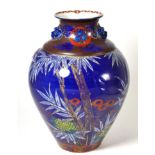 A 19th century Japanese blue ground baluster jar with mask handles, painted with foliage, 31cm