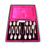 A cased set of silver teaspoons with tongs