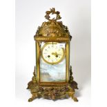 A gilt metal four glass striking mantel clock, circa 1900, scroll and acanthus leaf mounts, enamel