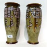 * A pair of Royal Doulton Stoneware vases decorated with flowers, 27cm