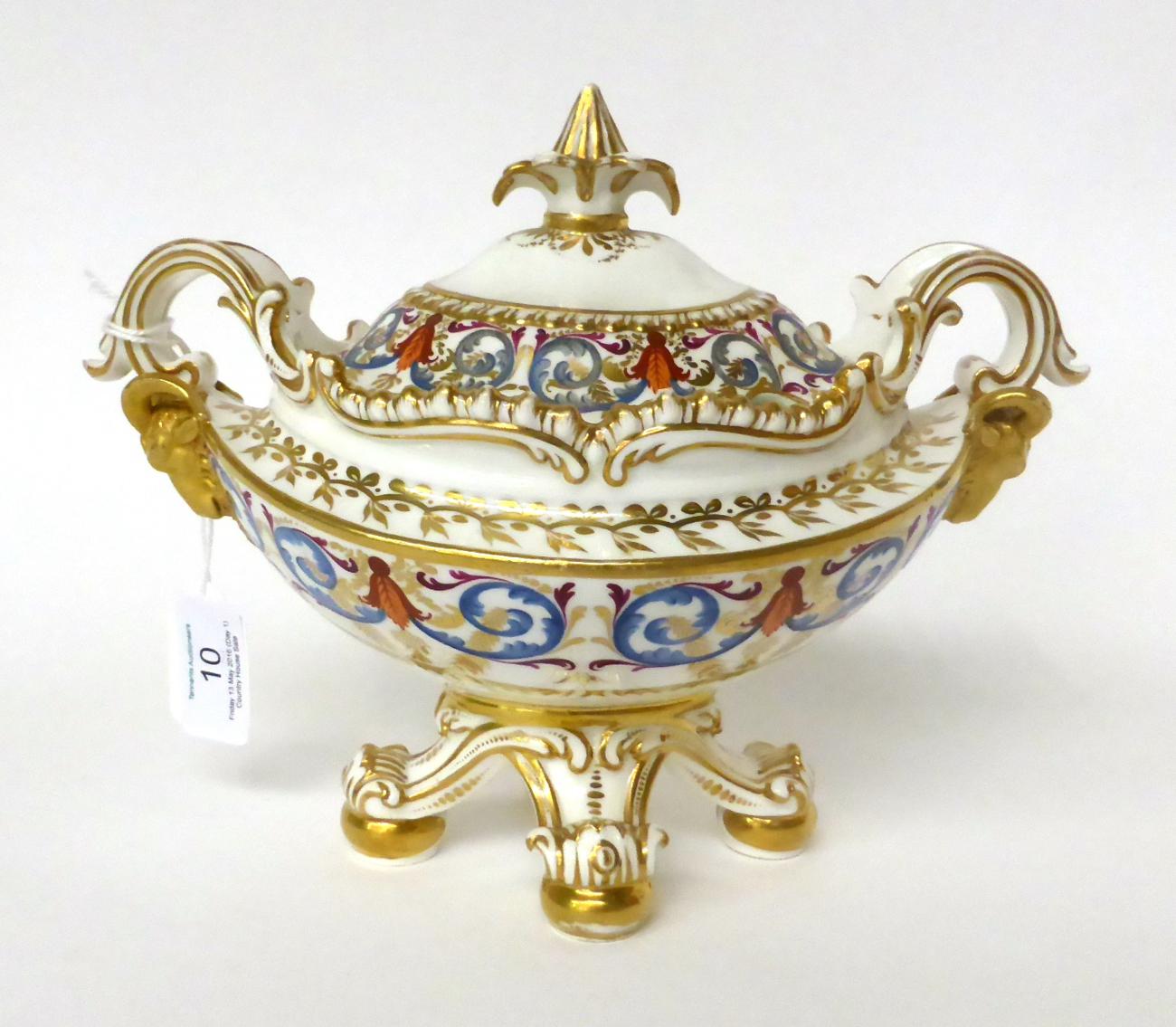 * An early 19th century English porcelain boat shaped saucer tureen and cover with classical
