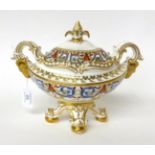 * An early 19th century English porcelain boat shaped saucer tureen and cover with classical