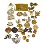 A Collection of Thirty Six Cap Badges, collar badges, buttons and shoulder titles in brass, white