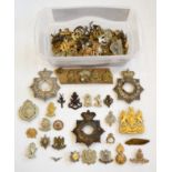 A Collection of Approximately One hundred and Thirty Cap Badges, in brass, white metal and