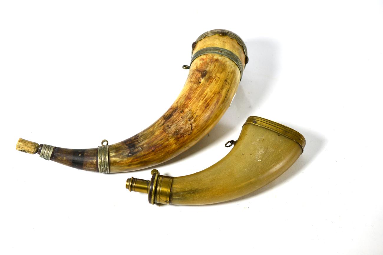 An 18th Century Powder Horn, with white metal mounts engraved with scrolling foliage, with domed