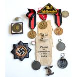 A German Third Reich Cross in Gold, cloth version, with paper backing; a Small Collection of