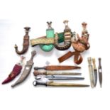 Four Various Saudi Arabian/Omani Jambiyas, with scabbards, one with gold wire-embroidered belt, 20th