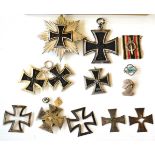 Two 1957 Versions of the 1939 Iron Cross, first and second class; a Dismantled 1939 Iron Cross, with