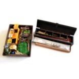 Accessories, including a boxed gun cleaning kit, another in an ebonised compartmented wood case,