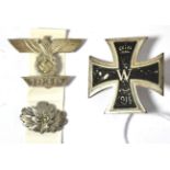 An Imperial German 1914 Iron Cross, first class, with vertical needle shape pin fastener; a 1939