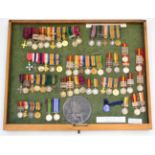 A Collection of Miniature Medal Groups, comprising an OBE group of ten; a First World War CBE,DFC,