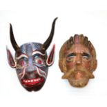 A Mexican Polychrome Wood Devil Mask, of oval form, with real antelope horns, the grimacing facial