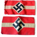 A German Third Reich Hitler Youth Armband, of three piece construction, the red linen ground applied