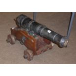 A Late 18th Century Black Painted Cast Iron Small Naval Cannon, three and a half pound, the 62cm two