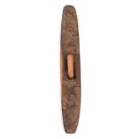 An Australian Aborigine Hardwood Parrying Shield, of slightly curved oblong form, each side carved