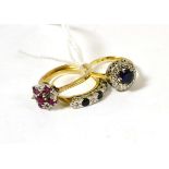 A 9ct gold ruby and diamond cluster ring, a 9ct gold sapphire and diamond half hoop ring and a