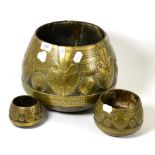 Three graduated Middle Eastern brass mounted turned wooden vessels