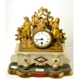 A French gilt metal mounted figural mantle clock on an alabaster plinth base