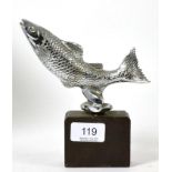 A salmon car mascot on weighted metal base