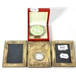 An Edwardian enamel pill box, red wood box and silver faced photo frame timepiece