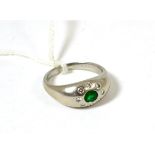 A platinum, diamond and emerald ring