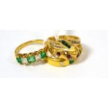 An emerald and diamond three stone ring, an emerald and diamond five stone ring, a ruby and