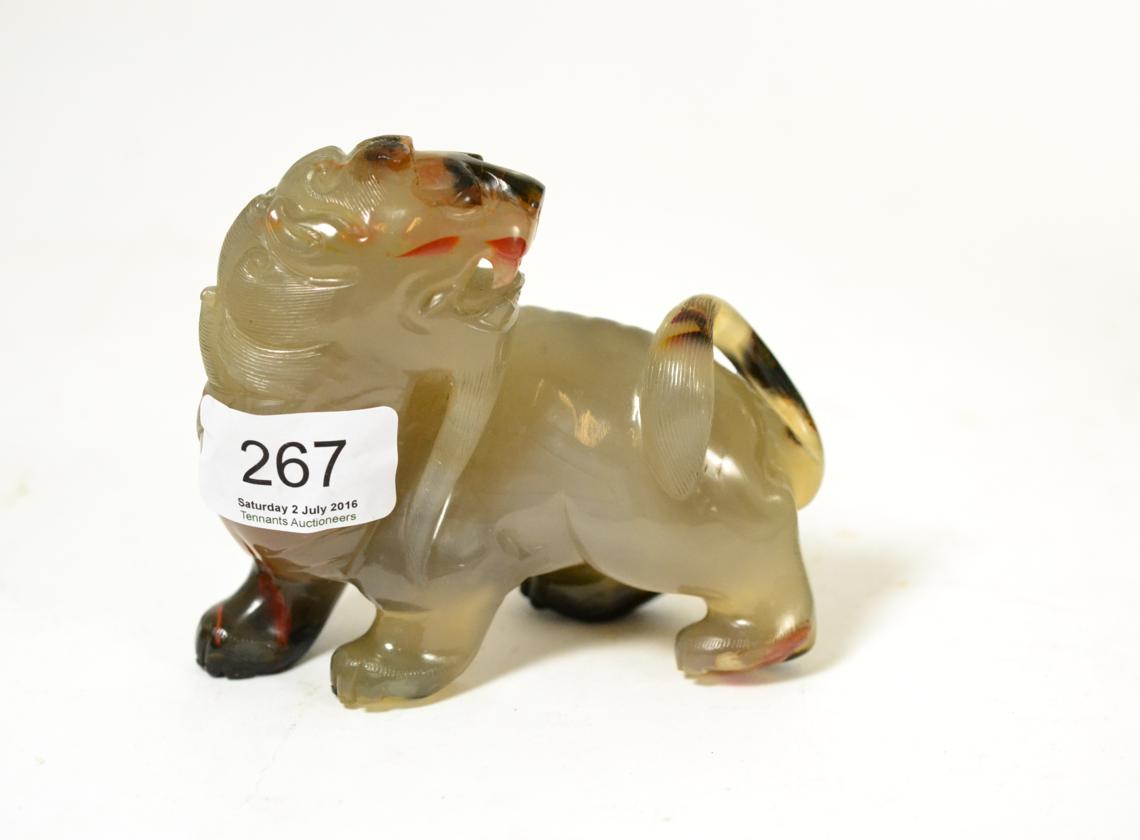 A Chinese carved hardstone lion