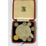 An 1887 gold half sovereign with six silver three penny bits and a 1935 cased medallion (8)