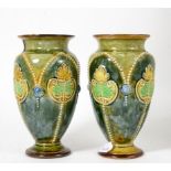 A pair of Doulton Lambeth flower vases, 17.5cm high Light crazing to both, otherwise ok