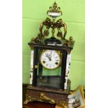A reproduction enamel and bronzed metal mantel clock