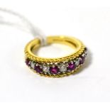 An 18ct gold ruby and diamond half hoop ring, the graduated round cut rubies alternate with round