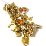 A 9ct gold charm bracelet hung with 24 charms