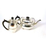 A silver teapot and a silver hot water jug