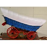 A scale model of a 'Conestoga American Wagon' complete with a model axe, jack and two buckets